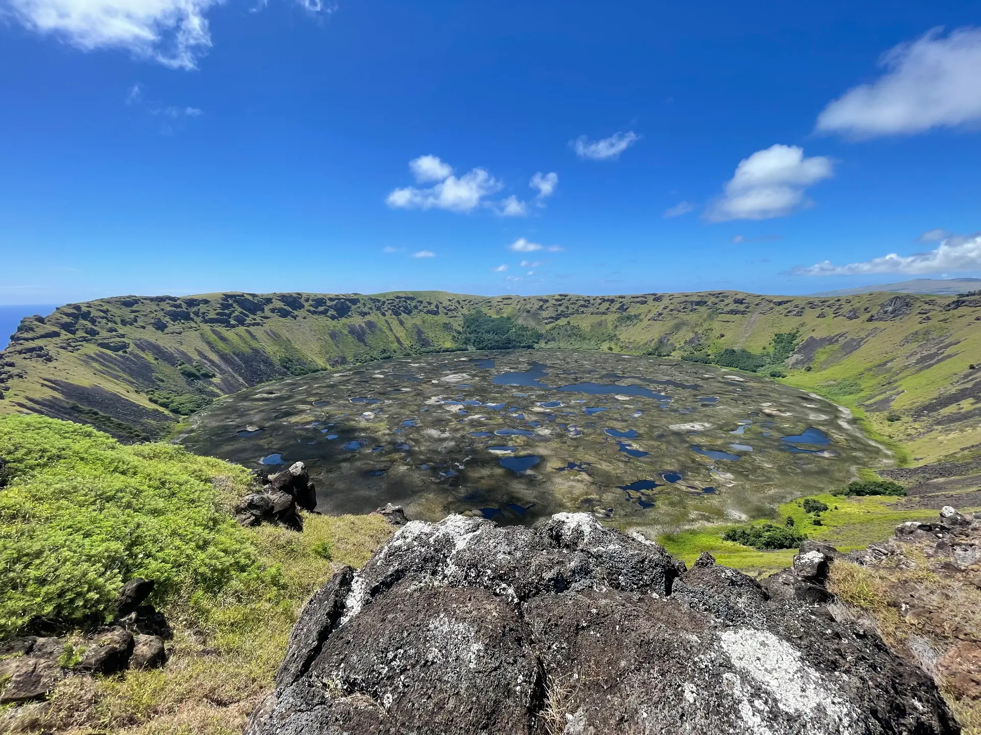 The Rano Kau crater lake seen from the rim under a blue sky